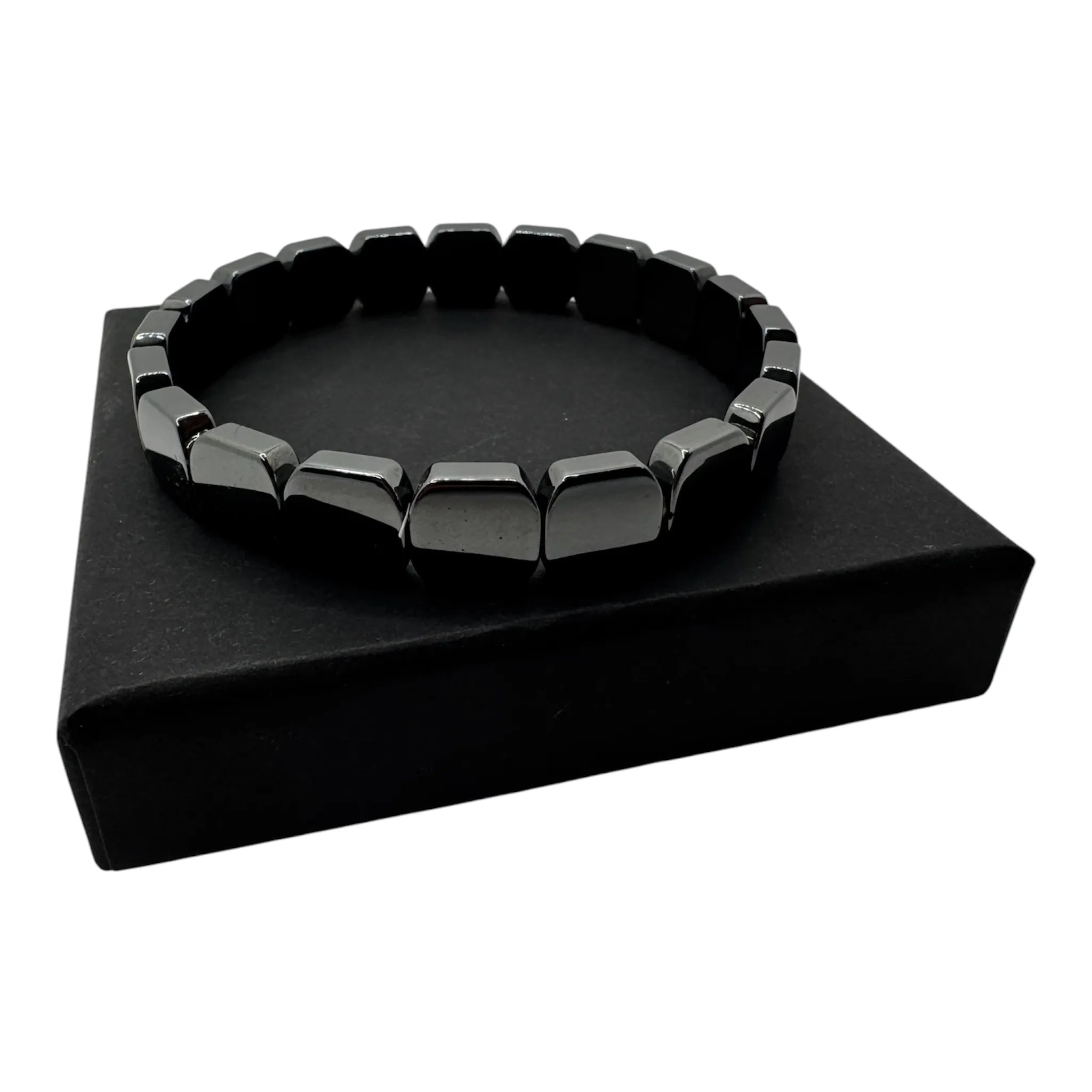 Minimalist men's hematite bracelet flat lay on dark surface