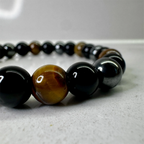 Close up of 8mm hematite obsidian and tiger's eye polished beads